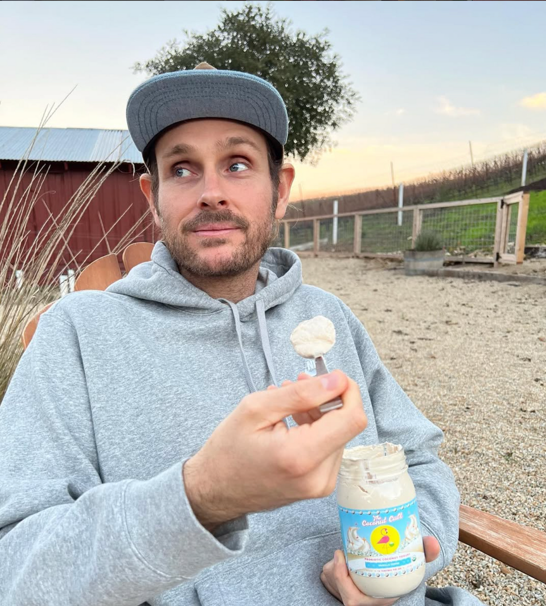 Founder of Coconut Cult Noah with a jar of Coconut yogurt